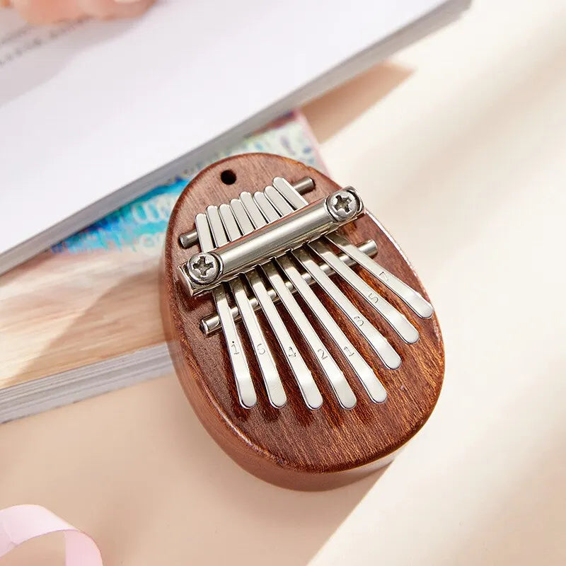 1 unidad de mini piano de pulgar de madera, juguetes musicales, 8 tonos, piano de dedo portátil para principiantes